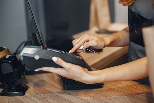 cashier pays by card through terminal